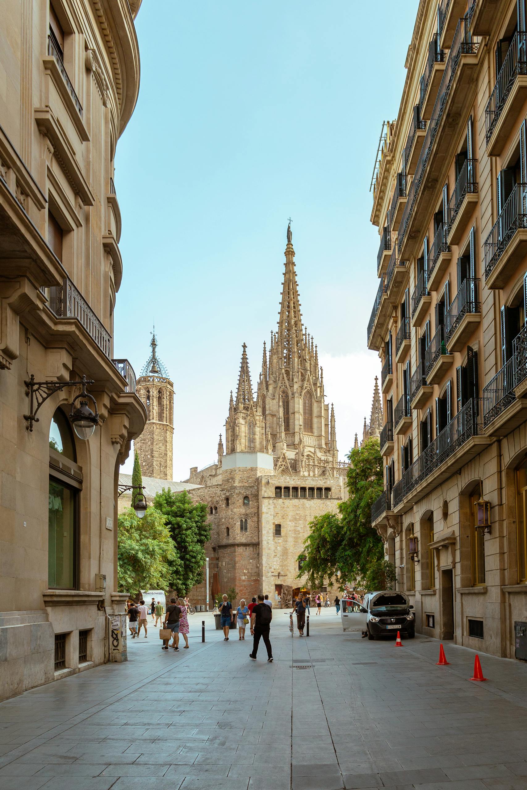 A vibrant street view showcasing the iconic Barcelona Cathedral's Gothic architecture.