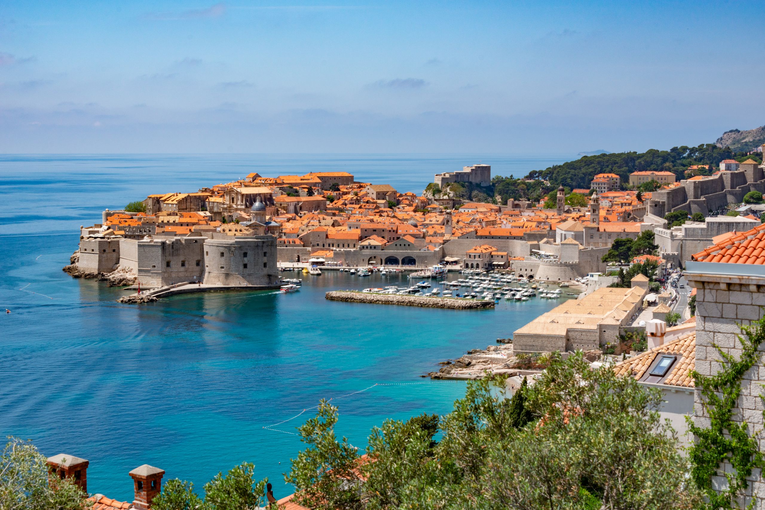 Scenic view of Dubrovnik's historic old town with iconic city walls and Adriatic coastline.